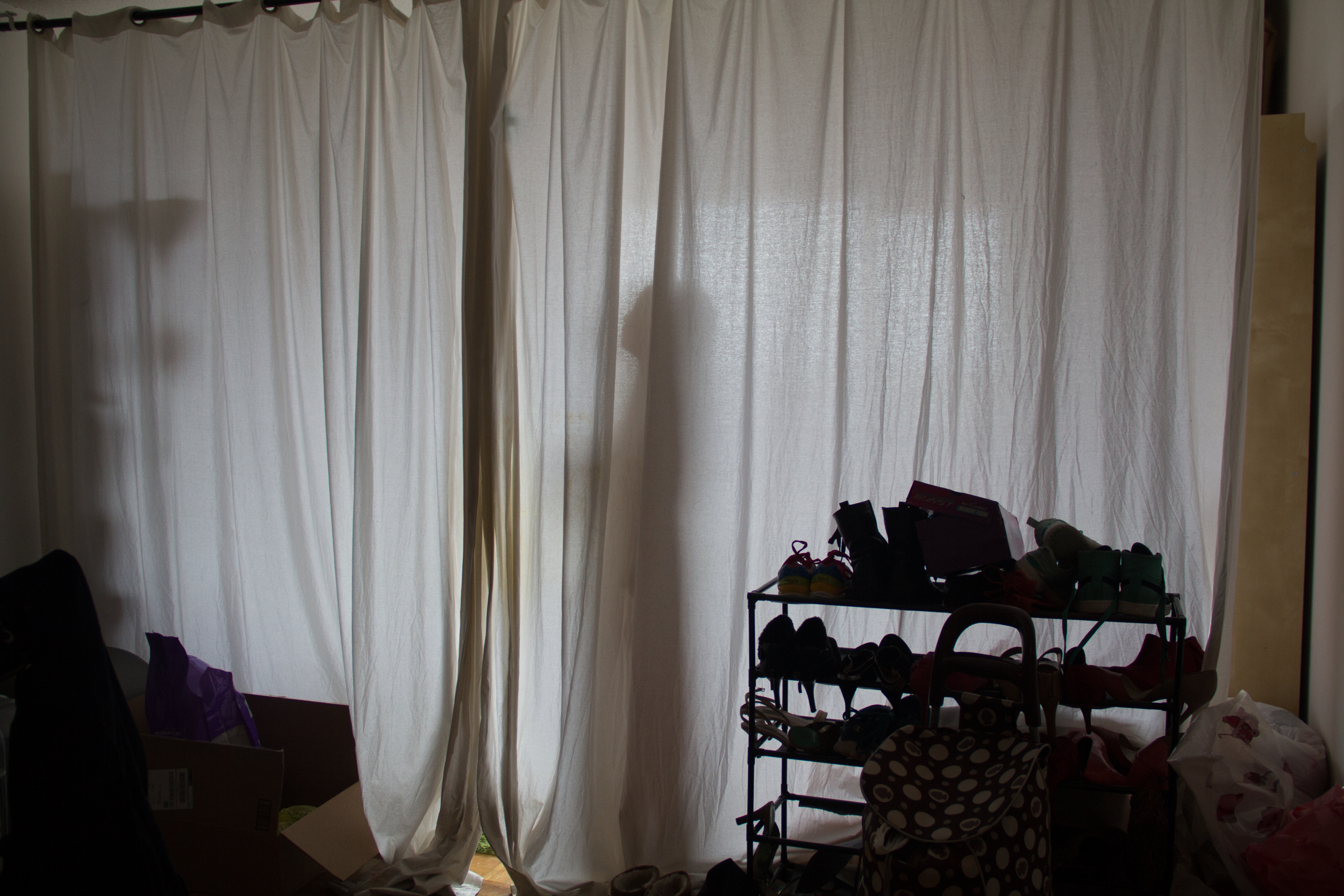 Kaidi lives at a living room of a 3-bedroom apartment with another three people on Roosevelt Island. Her "bedroom" is divided by a curtain.